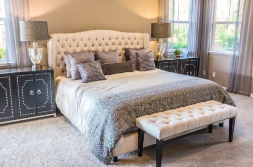 bed with tufted headboard and nightstands