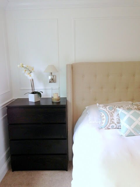 White bed with upholstered headboard