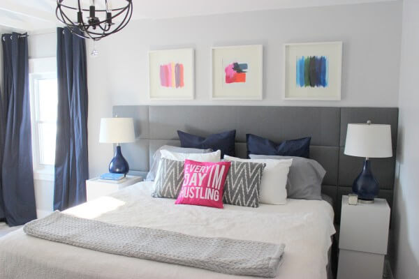 bed with grey tufted panel headboard