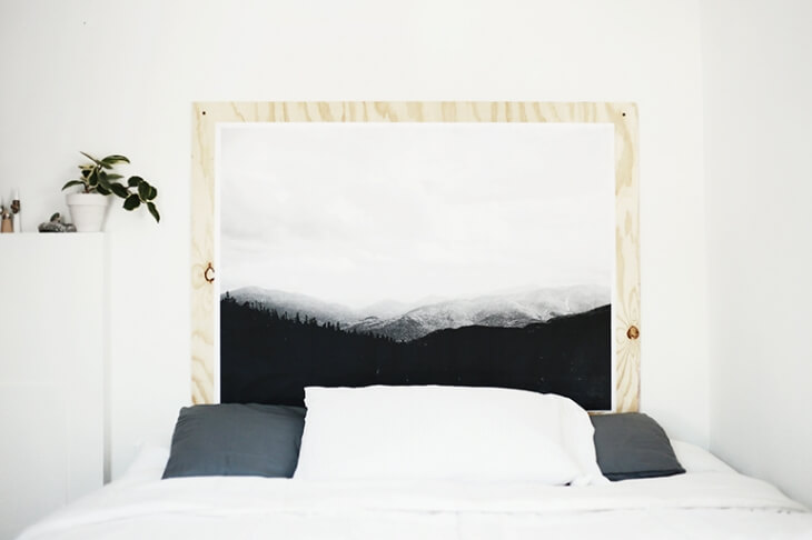 White bed with black and white print headboard.
