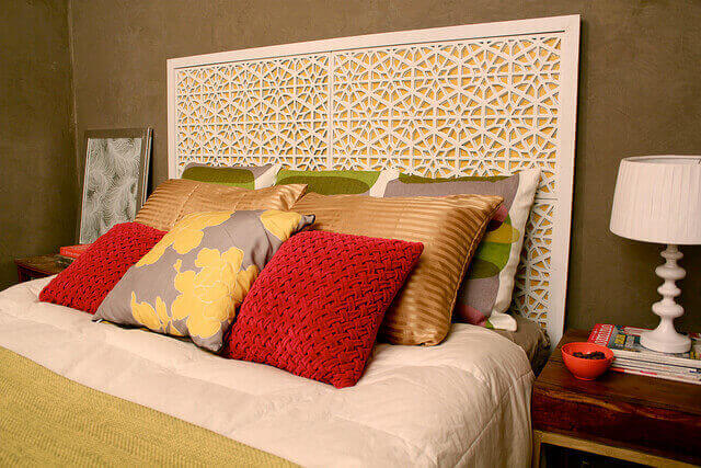 Bed with pillows and morocco headboard